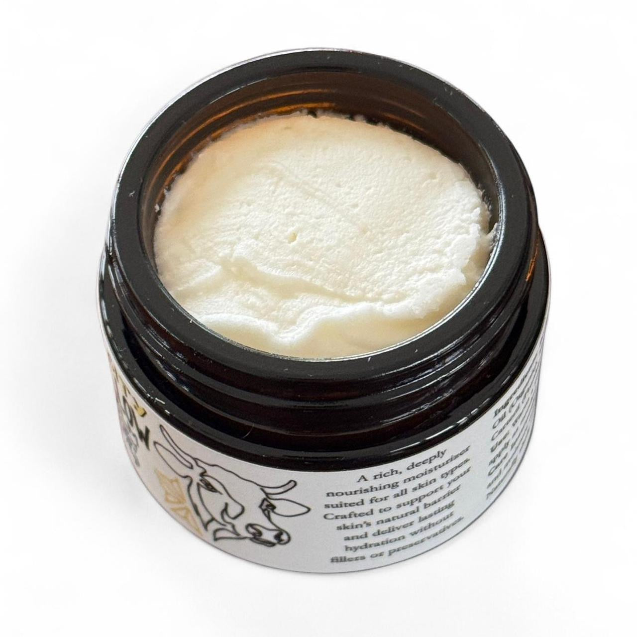 Jar of beef tallow skin balm cream with a black lid on a white background